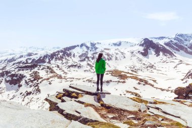 Hiker Woman Standing on the Top of Rila Mountain with Stunning View. Musala Peak in Bulgaria in the winter . Selective focus