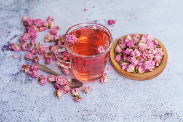 Rose buds tea in a pink cup . Tea made from tea rose petals