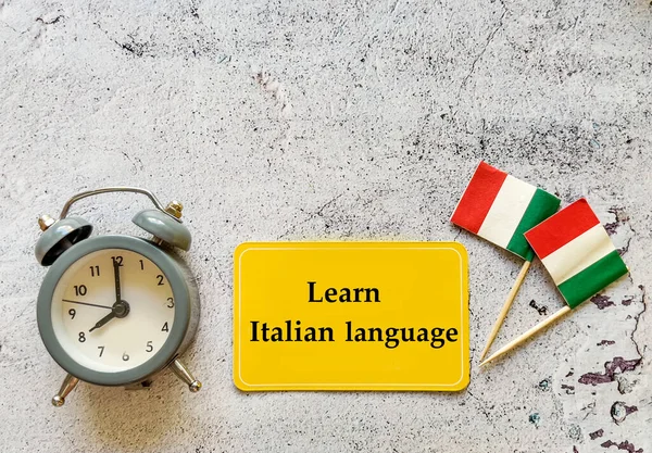 Learn Italian Language Education Concept with Italian flags ,alarm clock and message