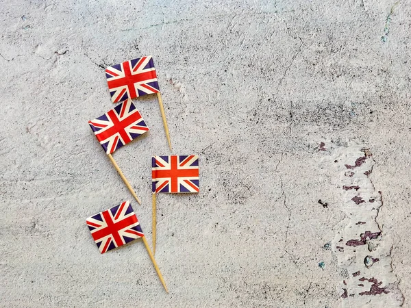 Britské Vlajky Miniaturní Papír Vlajky Šedém Texturovaném Pozadí Kopírovacím Prostorem — Stock fotografie