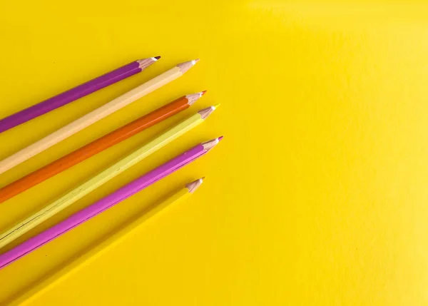 Yellow pencils with copy space on yellow background