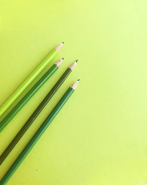 Green pencils with copy space on green background
