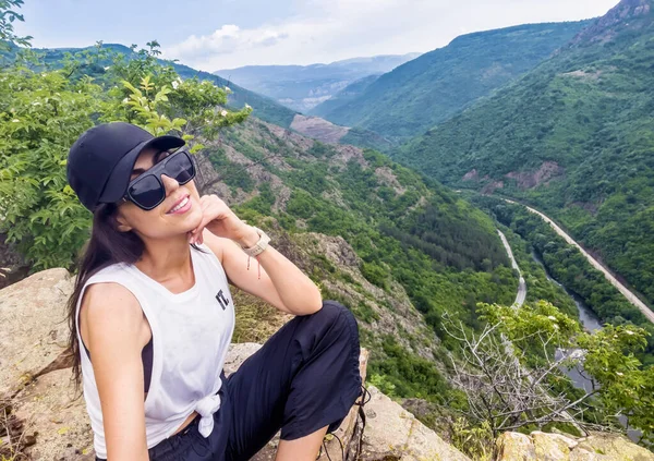 woman with glasses and sunglasses in the mountains