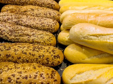 Whole grain bread with seeds and White bread in Bakery