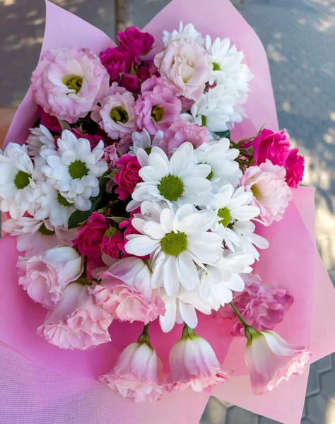 Beautiful big pink bouquet with pink roses and white chrysanthemums