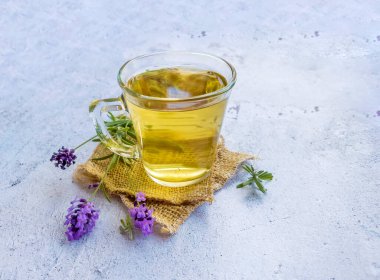 Lavender tea in a glass cup for better sleep, to calm nerves, improve skin health
