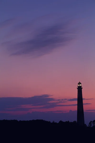 Vuurtoren en zonsondergang Stockfoto