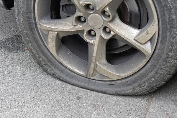 Flat tire deflated pneumatic car tyre wheel problem