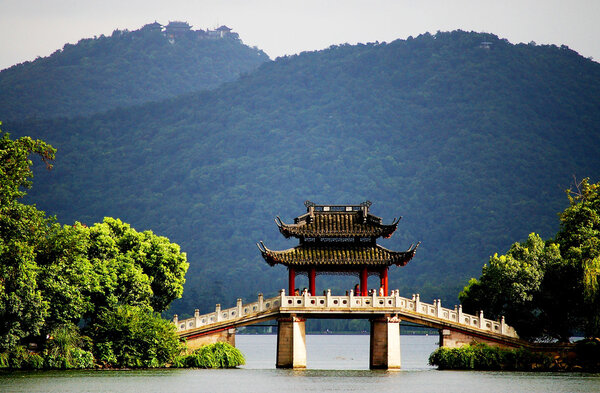 a pavilion bridge in west lake, hangzhou, china
