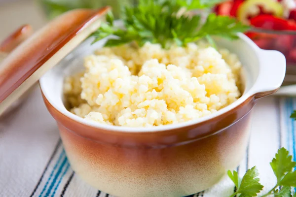 Porridge of millet in a ceramic pot — Stock Photo, Image