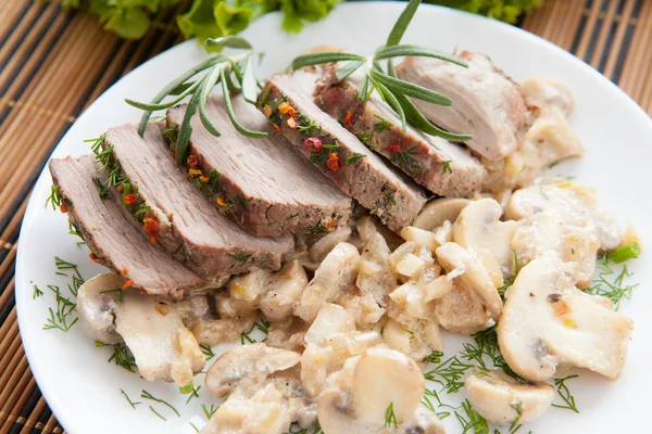 Pork cut into slices and mushrooms with cream — Stock Photo, Image