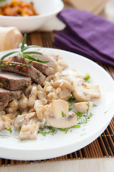 Pieces of meat and mushroom with cream sauce — Stock Photo, Image