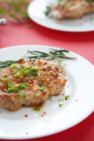 Grilled pork on a plate and a branch of rosemary — Stock Photo, Image