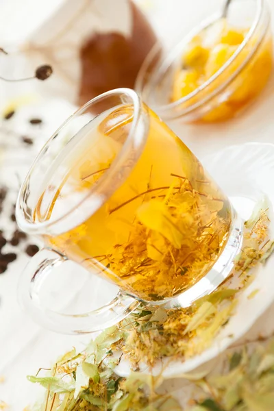 Golden tea with lime-blossom — Stock Photo, Image