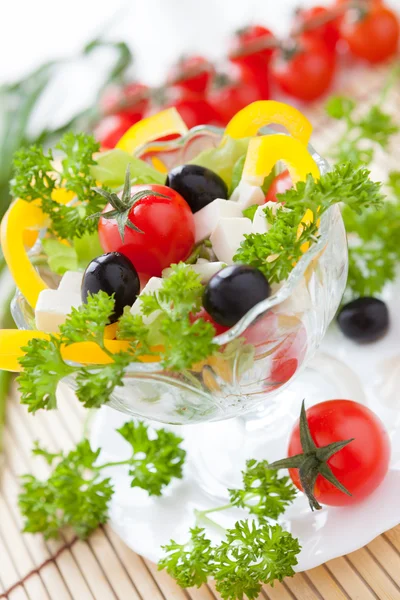 Beautiful vegetable salad in a transparent bowl — Stock Photo, Image