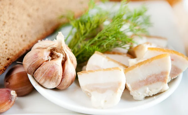 Chunks of fresh bacon and garlic — Stock Image Chunks of fresh bacon and garlic Stock Photo