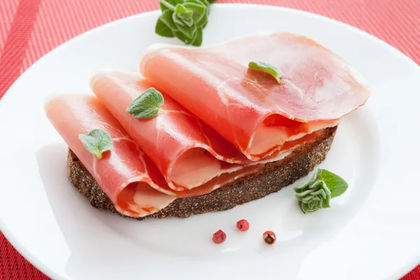 Three slices of jamon on bread — Stock Photo, Image