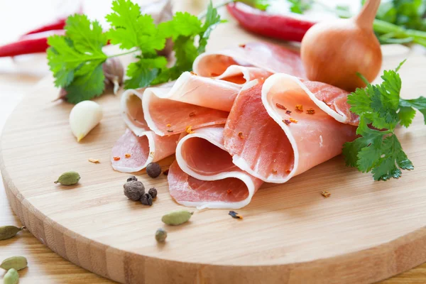 Thin slices of ham with herbs and spices — Stock Photo, Image