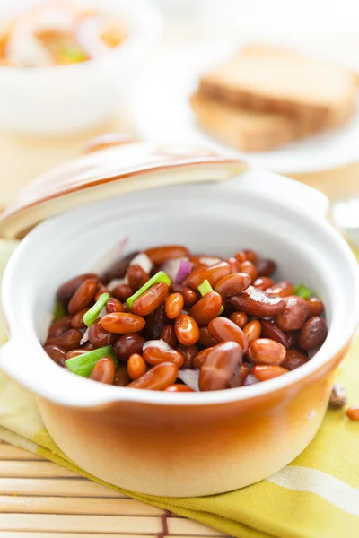 Beans in a ceramic pot on a napkin — Stock Photo, Image