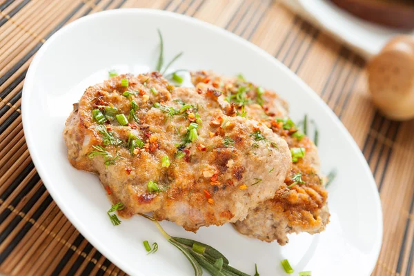 Fried cutlet with chives on a white dish — Stock Photo, Image