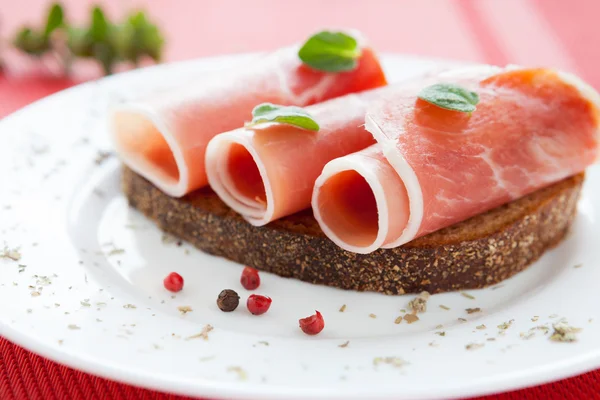 Three slices of ham wrapped in a roll — Stock Photo, Image