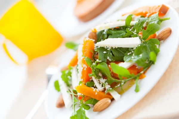 Pumpkin salad with feta on a white plate — Stock Photo, Image