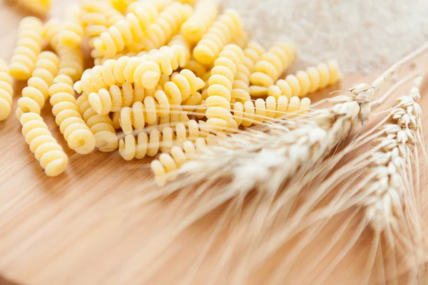 Bunch of macaroni and meal on the background — Stock Photo, Image