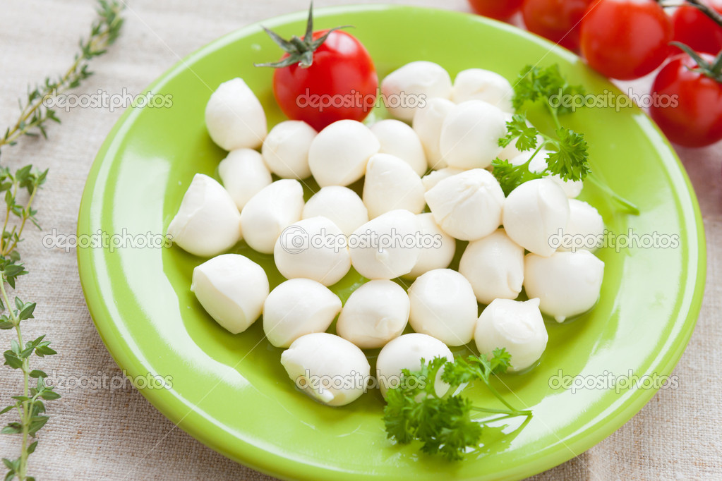 Small balls of mozzarella on a plate — Stock Photo © olhaafanasieva 20417331