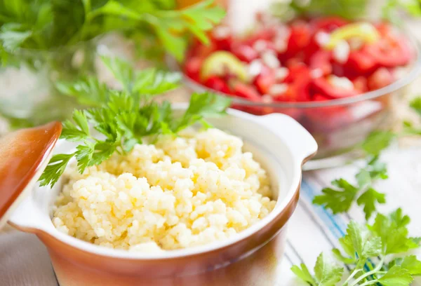 Porridge made of millet in a ceramic pot — Stock Photo, Image