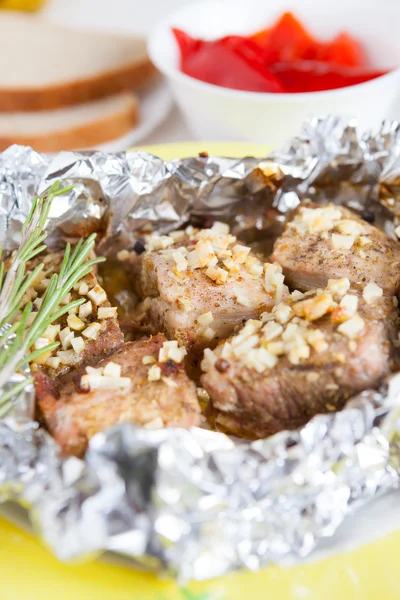 Pieces of beef baked in foil — Stock Photo, Image