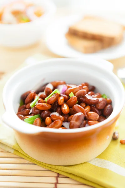 Brown beans in a ceramic pot on a napkin — Stock Photo, Image