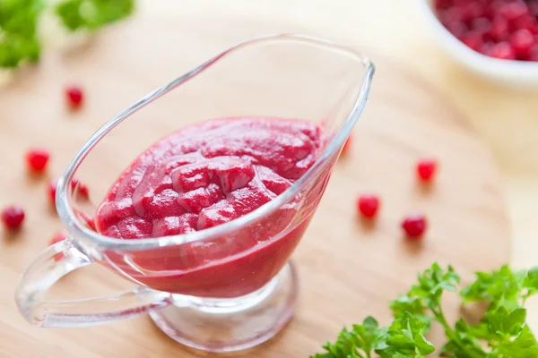 Thick flavorful cranberry sauce in a glass gravy boat — Stock Photo, Image