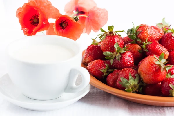 Cup of milk and juicy strawberries - a healthy breakfast