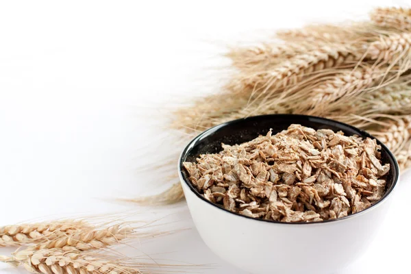 Wheat flakes and wheat spikelets — Stock Photo, Image