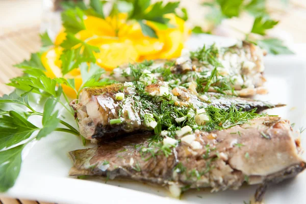 Fried river fish with garlic and herbs — Stock Photo, Image