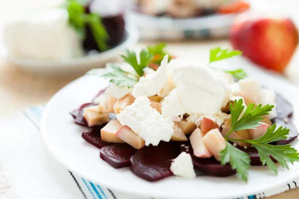 Delicious beet salad with cheese on a white plate — Stock Photo, Image