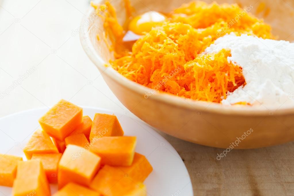 raw pumpkin - the pieces and grated in a bowl