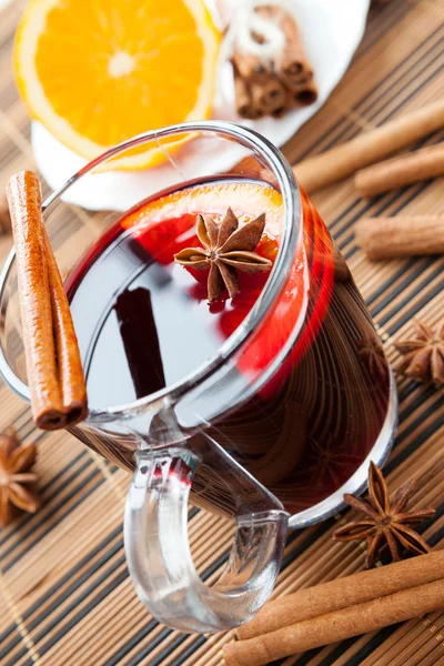 Large glass of hot wine with spices — Stock Photo, Image