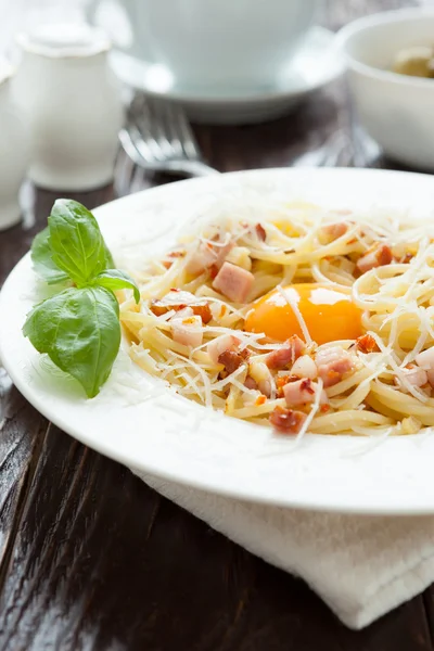 Spaghetti carbonara with yolk and parmesan cheese in a white bow — Stock Photo, Image
