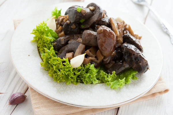 Boletus fried with vegetables on a white plate — Stock Photo, Image