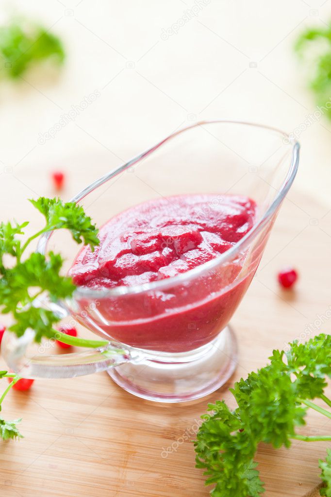 cranberry sauce, berry sauce in a gravy boat clear