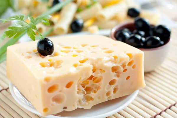 Piece of cheese with holes — Stock Photo, Image