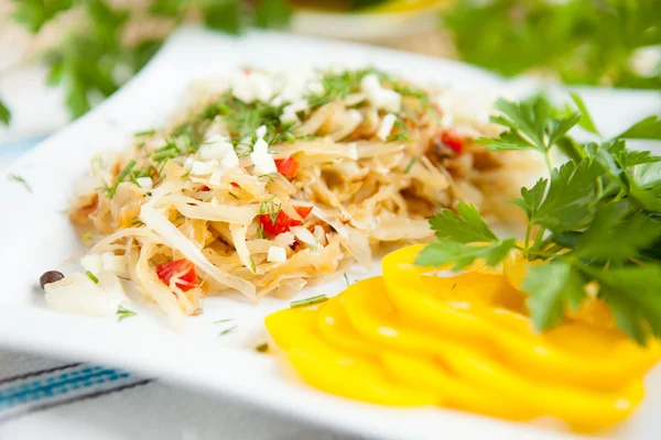 Stewed cabbage with vegetables on a white plate — Stock Photo, Image