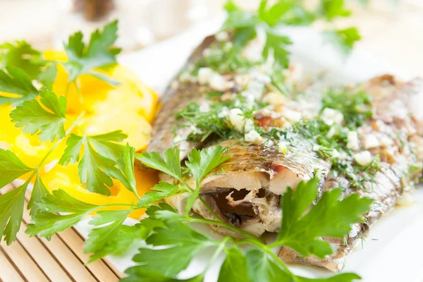Two fried fish fillets and fresh herbs — Stock Photo, Image