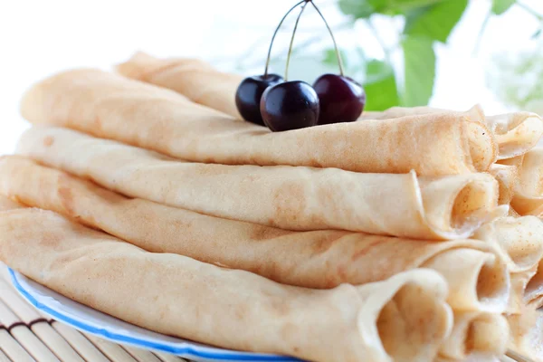 Pancakes stacked tubes on a white plate — Stock Photo, Image