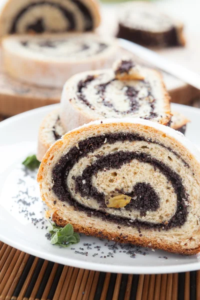 Pieces of poppy roll on a white dish — Stock Photo, Image