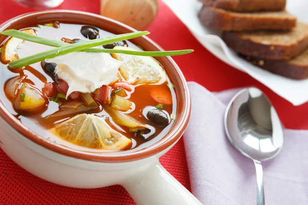 Sour soup with smoked sausage solyanka — Stock Photo, Image