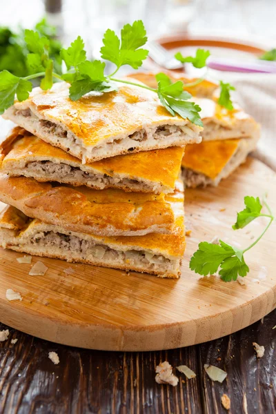 Delicious meat pie slices and parsley — Stock Photo, Image