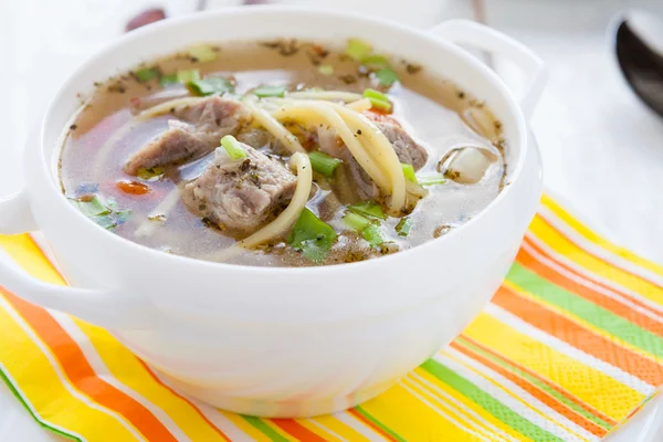 Nutritious meat soup in a white tureen — Stock Photo, Image