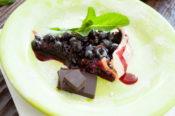 Trozo de pastel de bayas con chocolate en un plato —  Fotos de Stock